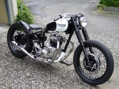 a black and white motorcycle parked on gravel