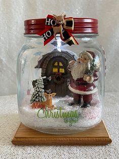 a glass jar with a santa clause in it