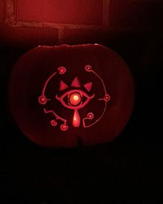 a carved pumpkin with an evil eye on it