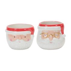 two ceramic mugs with santa faces on them