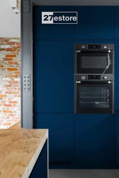 a kitchen with blue cabinets and an oven