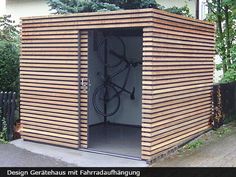 a wooden shed with a bicycle on the door