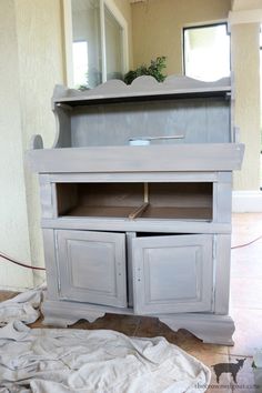 an old dresser is being painted with white paint