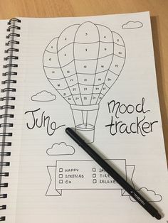 a notebook with a drawing of a hot air balloon and the words mood tracker on it