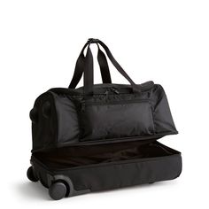 an open black suitcase with wheels and handles