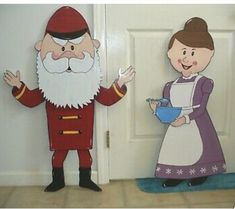 two paper cutouts of people standing in front of a door, one holding a bowl and the other wearing an apron