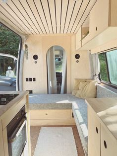 an interior view of a camper with the kitchen and living room in it,