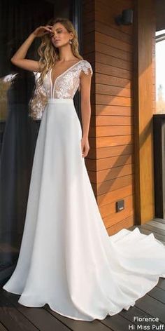 a woman in a white wedding dress standing on a porch