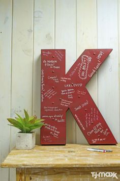 the letter k has been decorated with many names and phrases, along with a potted plant