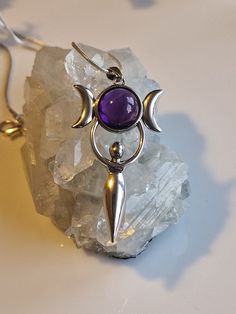 Elegantly crafted, this sterling silver pendant is a masterpiece that epitomizes the ethereal grace of the Moon Goddess. The heart of the pendant boasts a prominent, luminescent amethyst, symbolizing the full moon in its resplendent glory. With curves reminiscent of the divine feminine, this pendant pays homage to the goddess of fertility, offering a blend of elegance and profound symbolism. Every facet of this piece reflects meticulous craftsmanship, making it not just jewelry, but a treasured March Moon, Aquarius And Pisces, Fertility Goddess, Goddess Pendant, Moon Goddess, Silver 925 Necklace, Amethyst Necklace, Necklace Sterling Silver, Divine Feminine