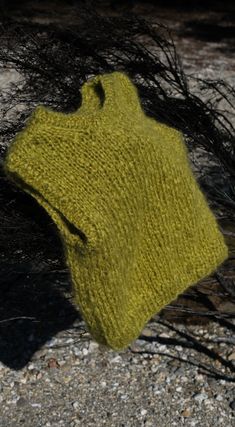 a yellow knitted hat laying on the ground