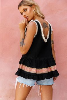 Black top.Surplice neckline.Fringe trim inserts.Crochet trim details.V-back.Loose fit.Fluted hem.  You'll want to pack your bags and head straight for the beach cause this top gives you all the vacay vibes. With its breezy, loose fit, fringe trim and crochet inserts, you won't want to take it off. Our Bali top looks amazing teamed with cut-off shorts and wedges, it's a Summery look we can't get enough of.   MODEL INFO  Model is wearing size XS Height: 5’6” Bust: 33” Waist: 25” Hips: 37 Chic Beach Tops With Frayed Hem, Beach Tops With Frayed Hem, Summer Beach Top With Frayed Hem, Bohemian Beach Tops With Frayed Hem, Black Top With Frayed Hem For Summer, Black Tops With Frayed Hem For Summer, Black Bohemian Top With Crochet Trim, Vacay Vibes, Yellow Bridesmaids