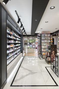 an empty store with shelves full of cosmetics and other items in the aisles, along with lights