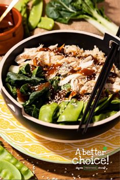 a bowl of food with chopsticks in it