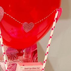 a red balloon filled with lots of candy and candies on top of a table