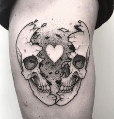 a black and white photo of a skull with a heart on it's side