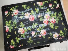 an old suitcase with flowers painted on it