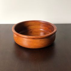 a wooden bowl sitting on top of a table