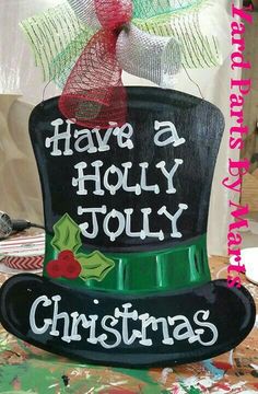 a black top hat that says have a holly jolly christmas