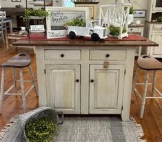 a kitchen island with two stools in front of it