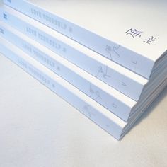 four books sitting on top of each other with writing on the covers in chinese and english