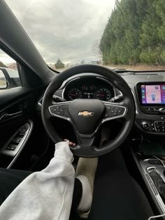 the interior of a car with dashboard, steering wheel and touch screen display on it