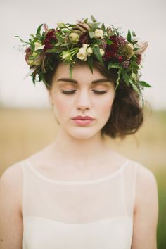 a woman wearing a flower crown in a field