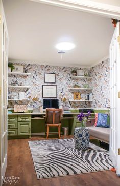 a living room filled with furniture and a zebra rug on top of a hard wood floor