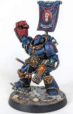 a warhammer with a banner on it's head and two fists in his hand