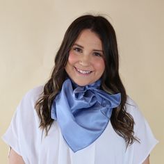 Brunette model wearing a short sleeve, white top with a slate blue scarf tied around her neck. This model is pictured in front of a beige background. Blue Bandana Scarf As Gift, Blue Bandana As Gift, Blue Silk Scarf As Gift, Blue Satin Silk Scarf As Gift, Blue Satin Silk Scarf For Gift, Wild Rags, Giddy Up Glamour, Wild Rag, New Line