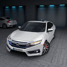 two white cars parked next to each other in a garage