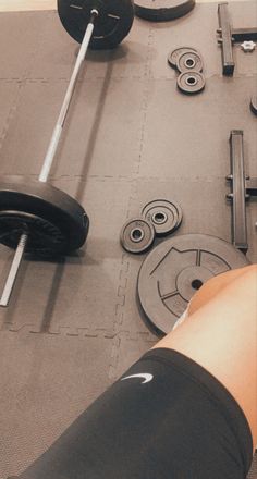 a gym floor with weights and barbells on it