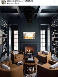 a living room filled with furniture and a fire place in the middle of a room