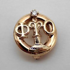 "Vintage Phi Tau Omicron fraternity pin or badge, made of 10K (.417) yellow gold with Diamond accent. Inscribed on the reverse: C. B. AP-62. This wonderful pin is 1/2\" in diameter and weighs 2.3 grams. EA3029" Gold Round Pins For Anniversary, Face Brooch, Badge Pin, Fraternity, Pin Badges, 10k Gold, San Jose, Gold Diamond, Yellow Gold