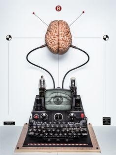 an old typewriter with a brain on top of it