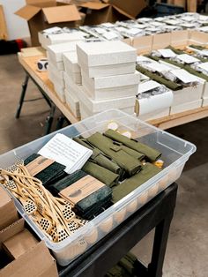 boxes and packages are stacked on top of each other at a table in a warehouse