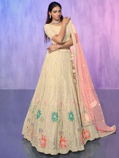 Add a touch of elegance and grace to your ethnic wardrobe with our captivating off-white sequins net lehenga choli with dupatta. This exquisite ensemble is meticulously crafted with intricate sequin and embroidered work, showcasing the richness of Indian craftsmanship.
Designed in an off-white color, the net material lehenga exudes a sense of purity and radiance. The sequins and embroidered work further enhance its beauty, adding a glamorous touch to the overall look. The semi-stitched lehenga c Beige Lehenga With Resham Embroidery In Georgette, Beige Georgette Lehenga With Resham Embroidery, Beige Georgette Lehenga With Zari Work, Beige Lehenga With Traditional Drape In Georgette, Beige Lehenga In Traditional Drape Style, Traditional Drape Beige Georgette Lehenga, Beige Georgette Lehenga, Festive Beige Georgette Lehenga, Festive Off White Choli With Sheer Dupatta