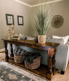 a living room with a couch, table and baskets on the floor next to it