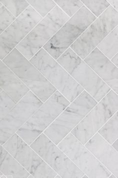 a white marble tile floor that looks like it is made out of herringbones