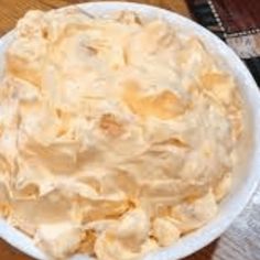 a white bowl filled with food on top of a wooden table