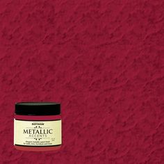 a jar of metallic paint sitting on top of a red wall with a black lid