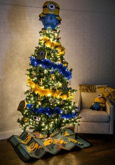 a minion christmas tree decorated with blue and yellow ornaments, lights and decorations on it