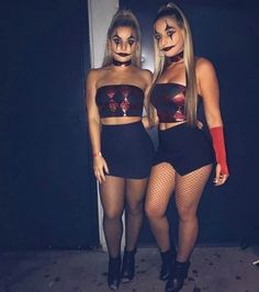 two women dressed up in costumes standing next to each other with their hands on their hipss