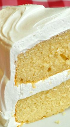 a close up of a slice of cake with white frosting