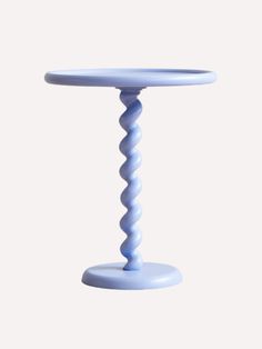 a white table with a spiral design on the top and bottom, against a white background