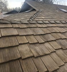 the roof of a house that has been cleaned and is covered with wood shingles