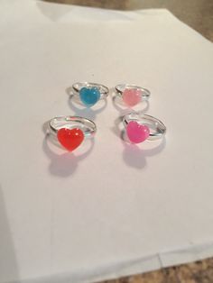 three heart shaped rings sitting on top of a piece of paper