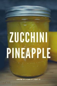 a jar filled with yellow liquid sitting on top of a wooden table