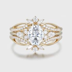 a gold ring with an oval cut diamond surrounded by smaller round diamonds