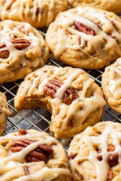 several cookies with pecans and icing on a cooling rack